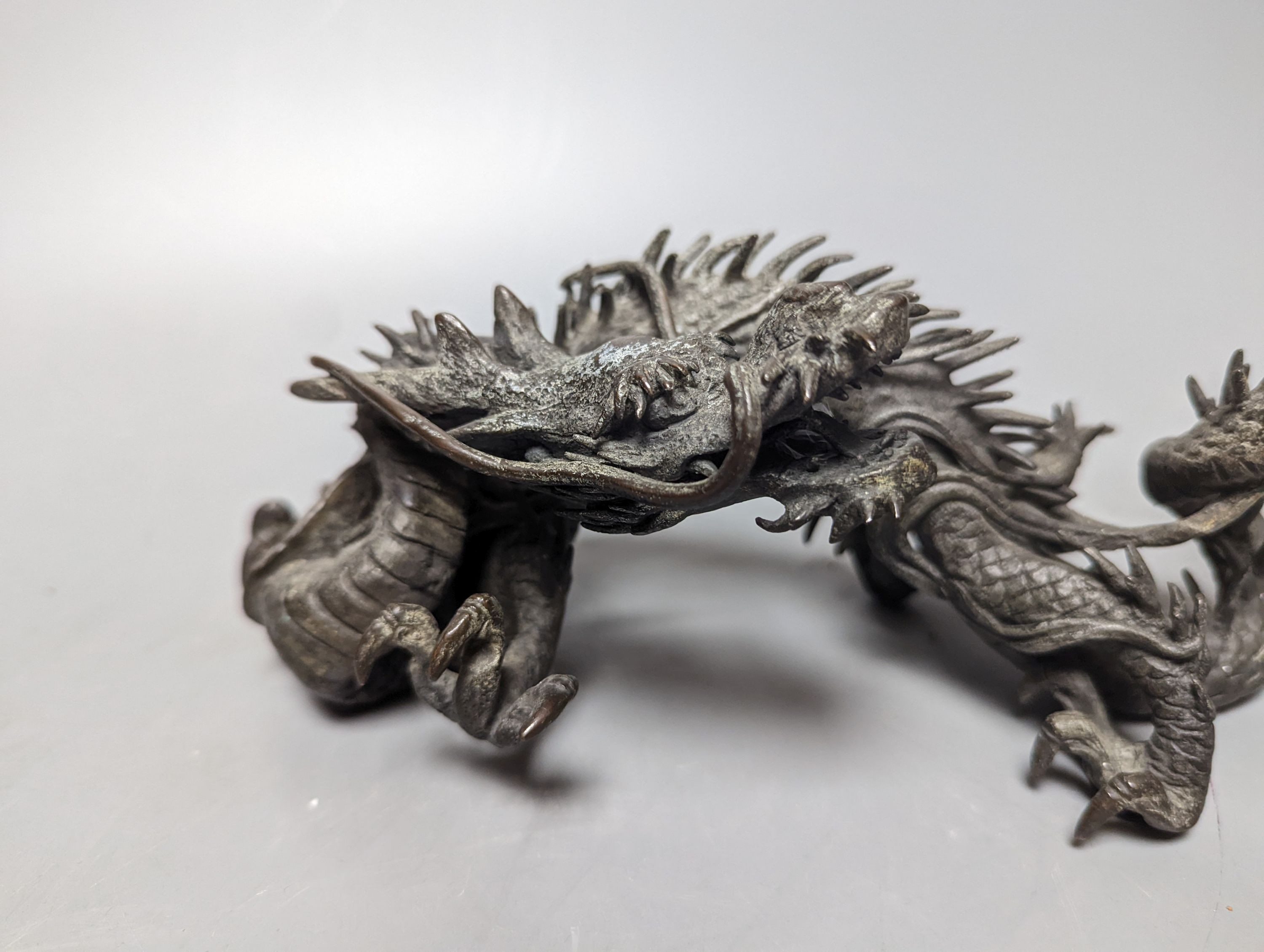A pair of early 20th century Japanese bronze figures of dragons 22cm